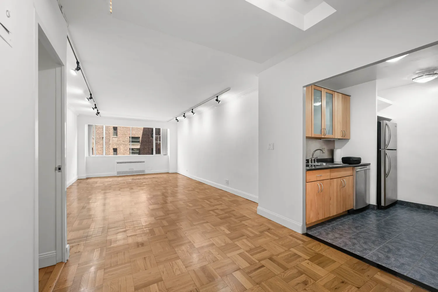 a kitchen with granite countertop a refrigerator and a stove top oven