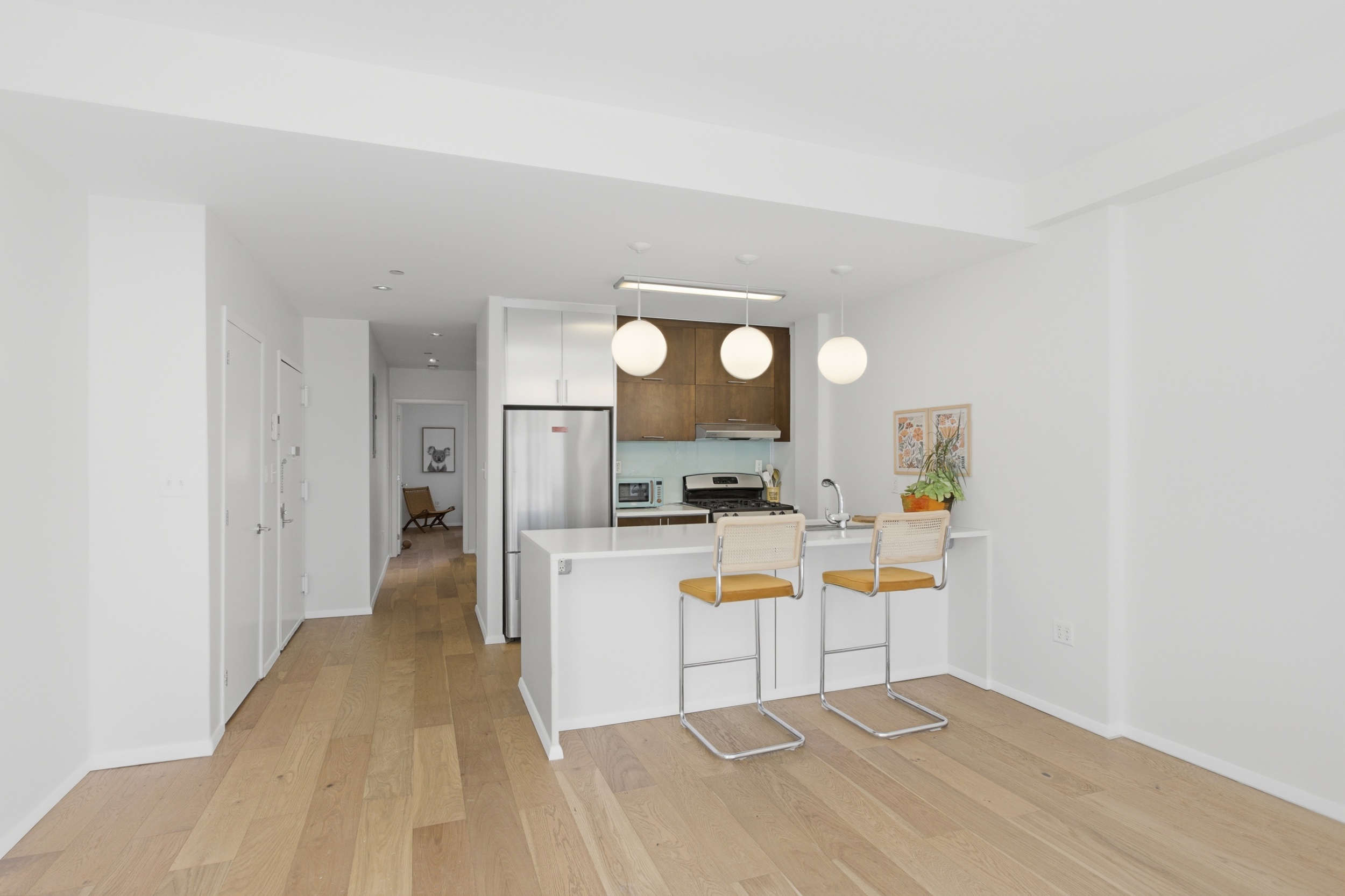 433 Warren Street, Unit 2C Brooklyn, NY 11217 - Photo 3 of 19 a view of a kitchen with wooden floor
