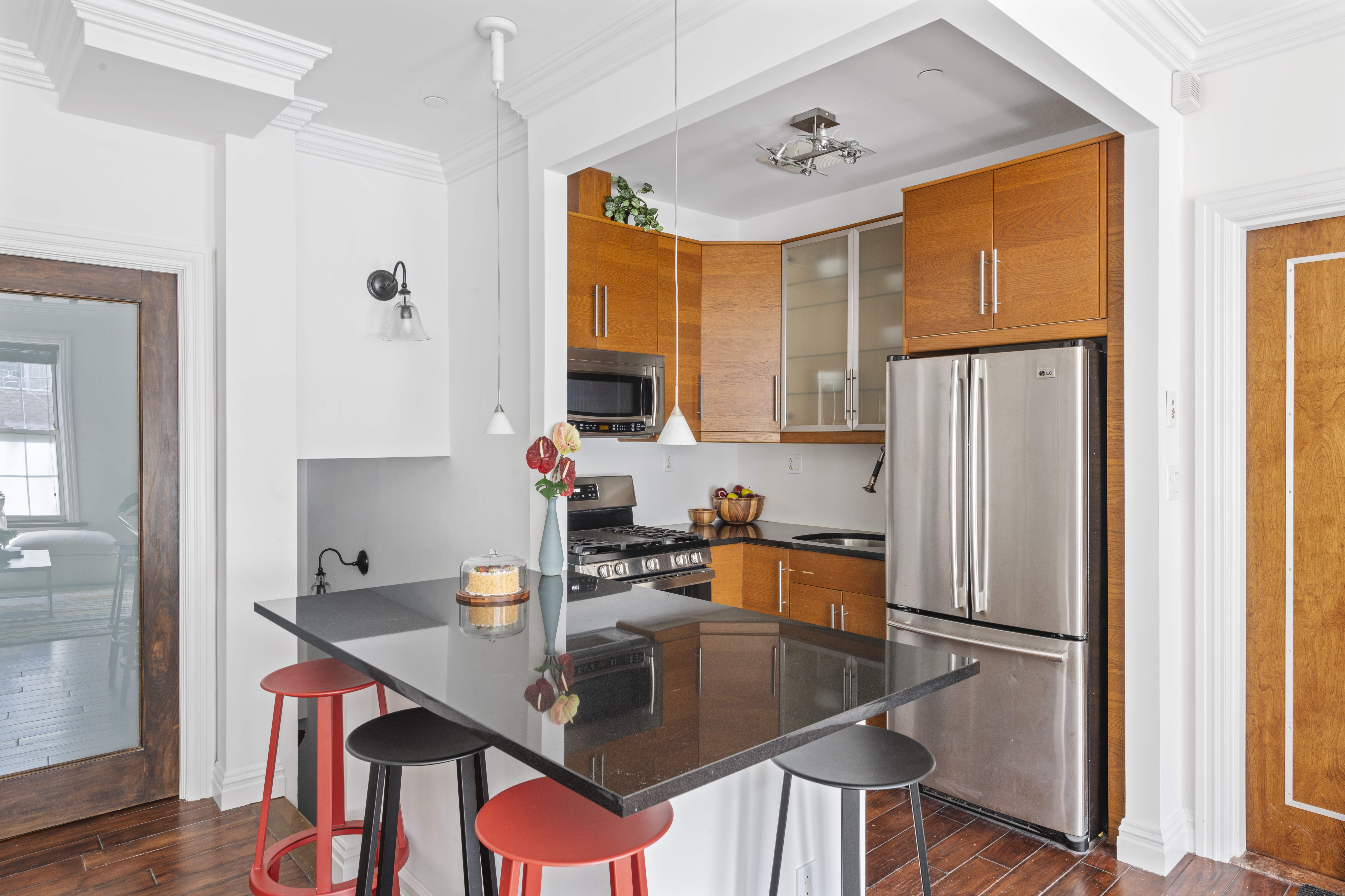 37 Powers Street, Unit 1A Brooklyn, NY 11211 - Photo 3 of 9 a kitchen with stainless steel appliances granite countertop a refrigerator a sink dishwasher and a refrigerator with wooden floor