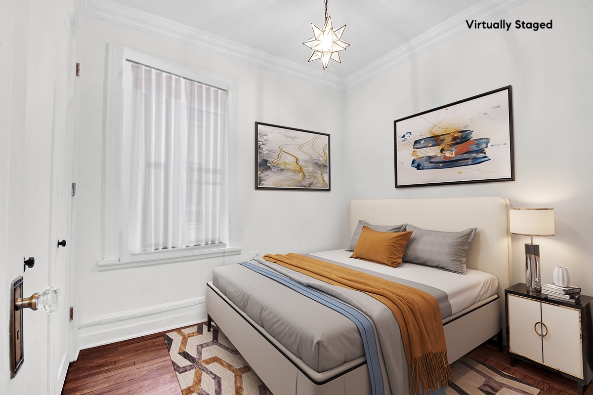 47 Fort Washington Avenue, Unit 55 Manhattan, NY 10032 - Photo 14 of 20 a bedroom with a bed and a painting on the wall