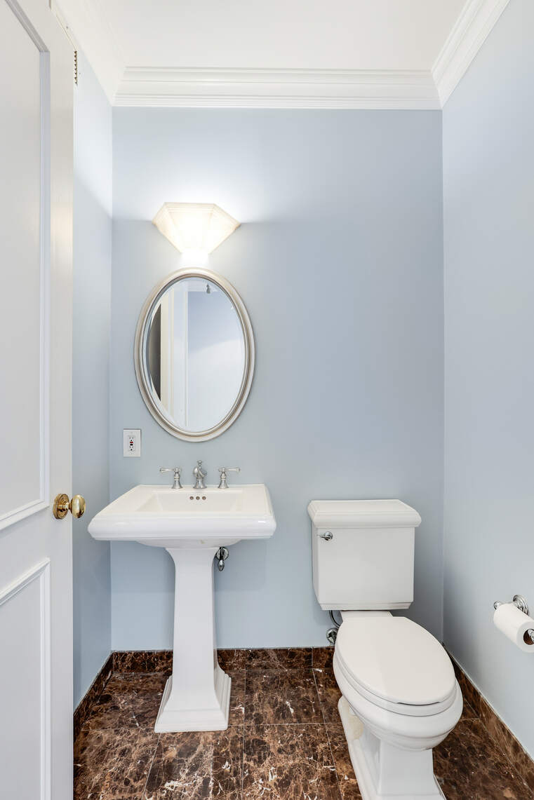 2 Columbus Avenue, Unit 17C Manhattan, NY 10023 - Photo 21 of 26 a bathroom with a sink mirror toilet and a mirror