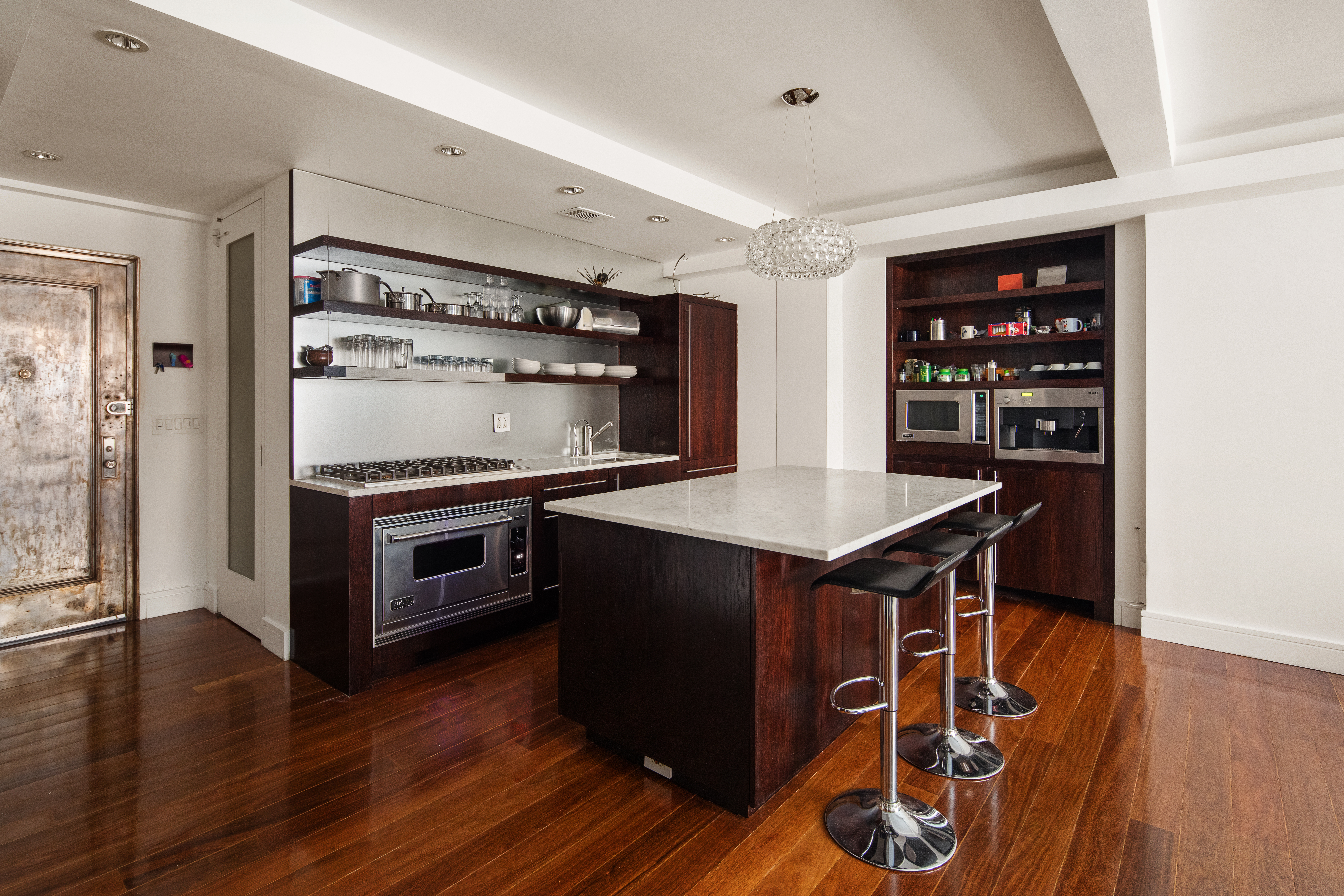 410 West 24th Street, Unit 4J Manhattan, NY 10011 - Photo 4 of 11 a kitchen with a stove a refrigerator and a wooden floor