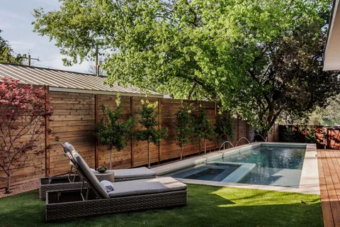 a bedroom with a large bed and a painting on the wall