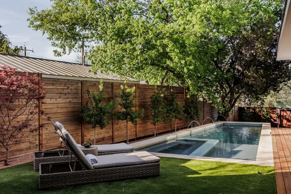 a bedroom with a large bed and a painting on the wall
