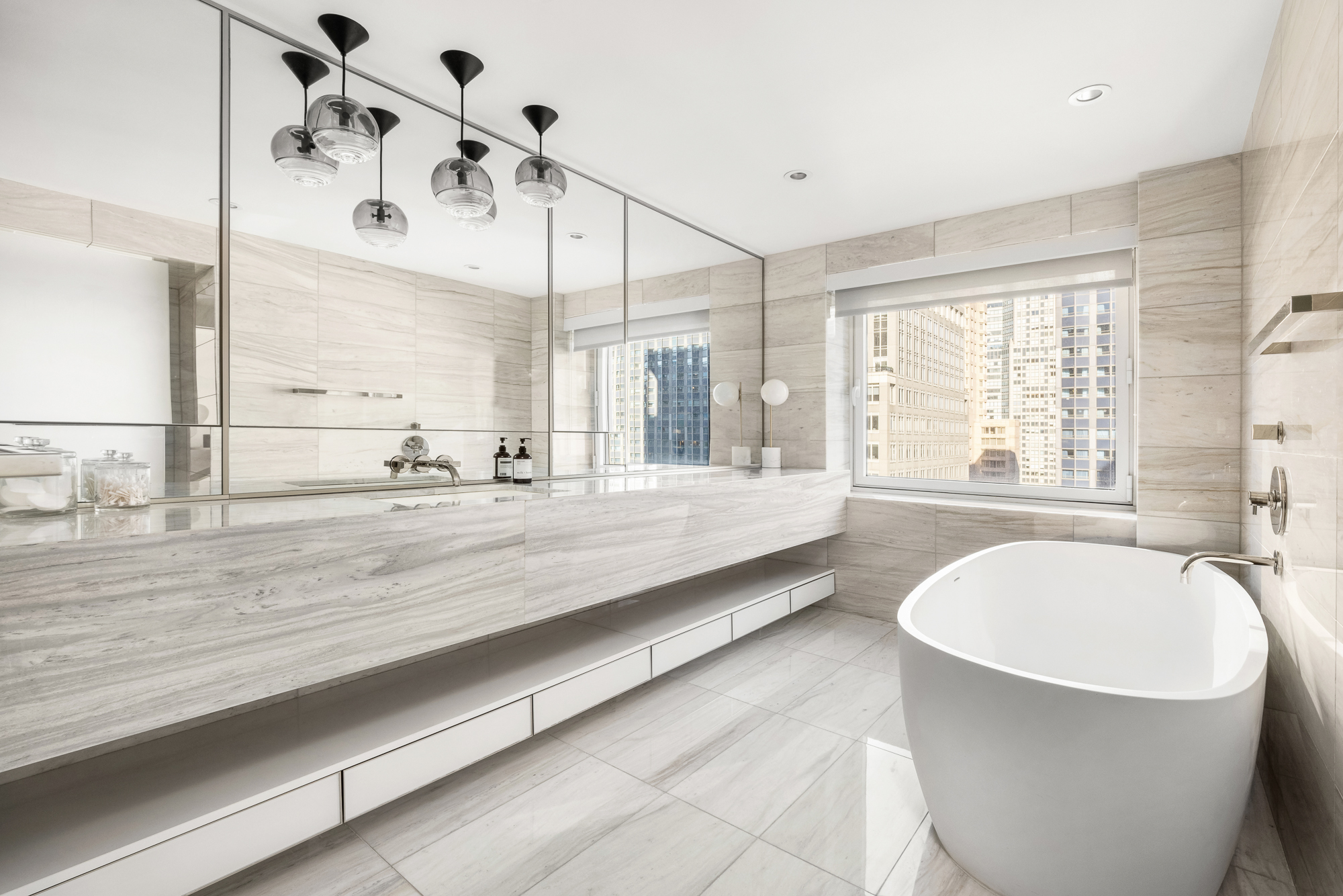 135 West 52nd Street, Unit 40A Manhattan, NY 10019 - Photo 15 of 24 a spacious bathroom with a large tub and shower