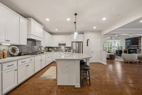 a bathroom with a granite countertop double vanity sink and a mirror