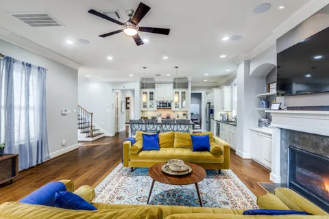 a living room with furniture and kitchen view