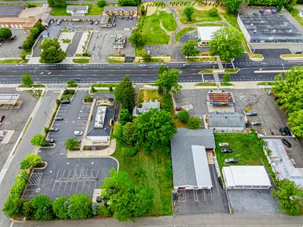 an aerial view of multiple houses with yard