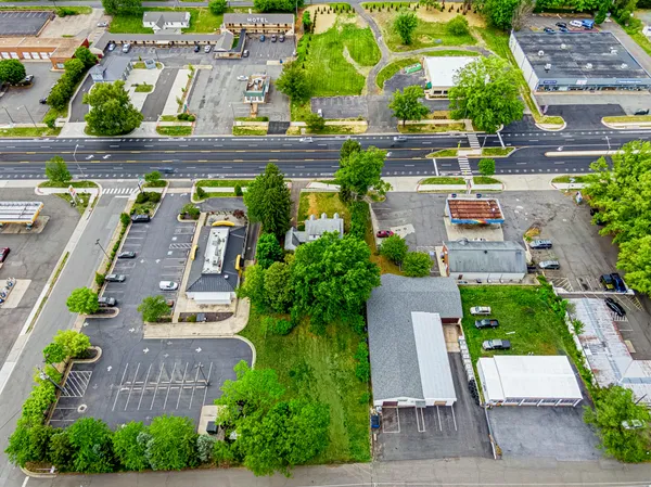 an aerial view of multiple houses with yard