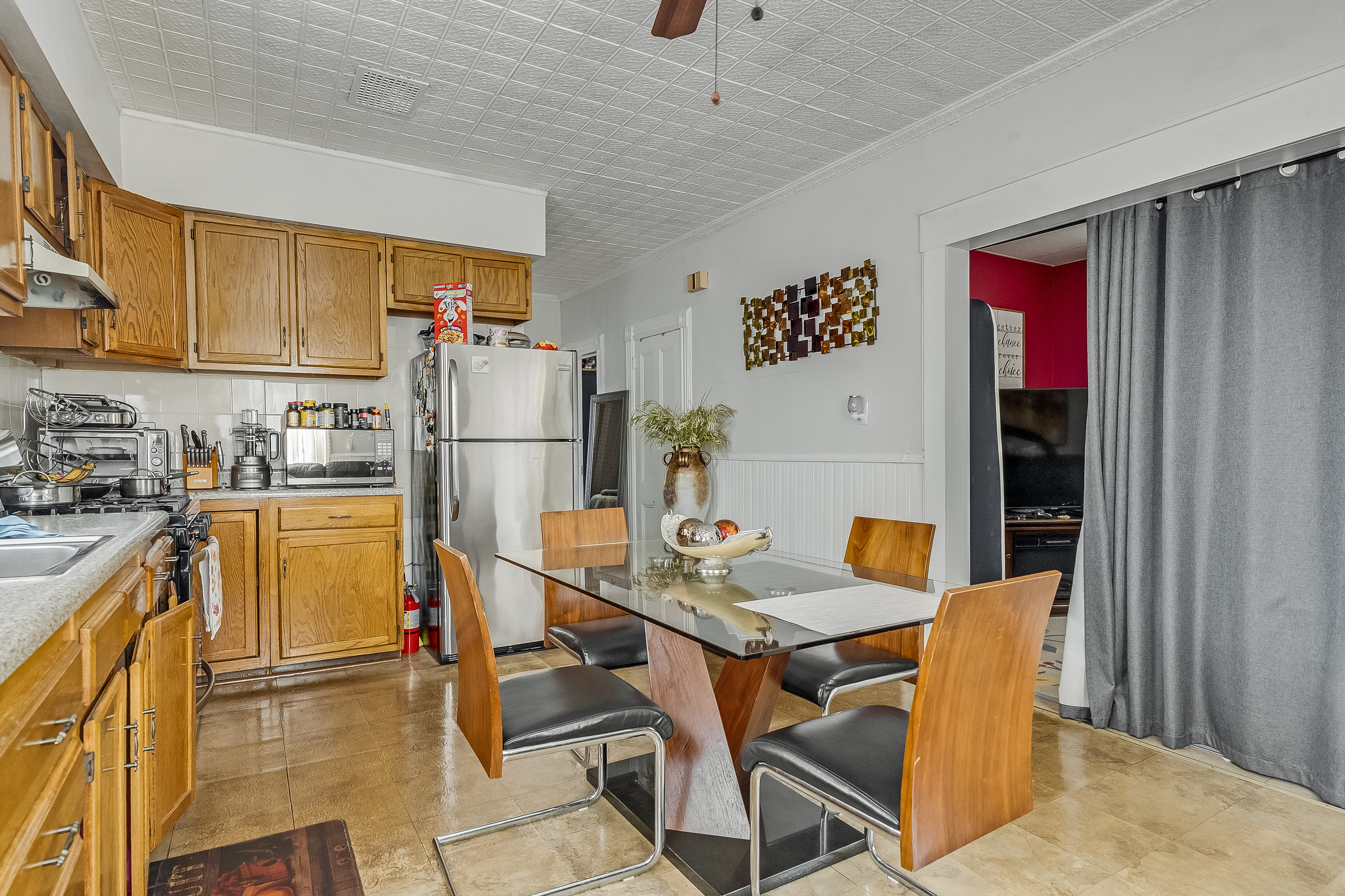 102-104 22nd Avenue Paterson, NJ 07513 - Photo 9 of 37 a kitchen with a table chairs refrigerator and cabinets