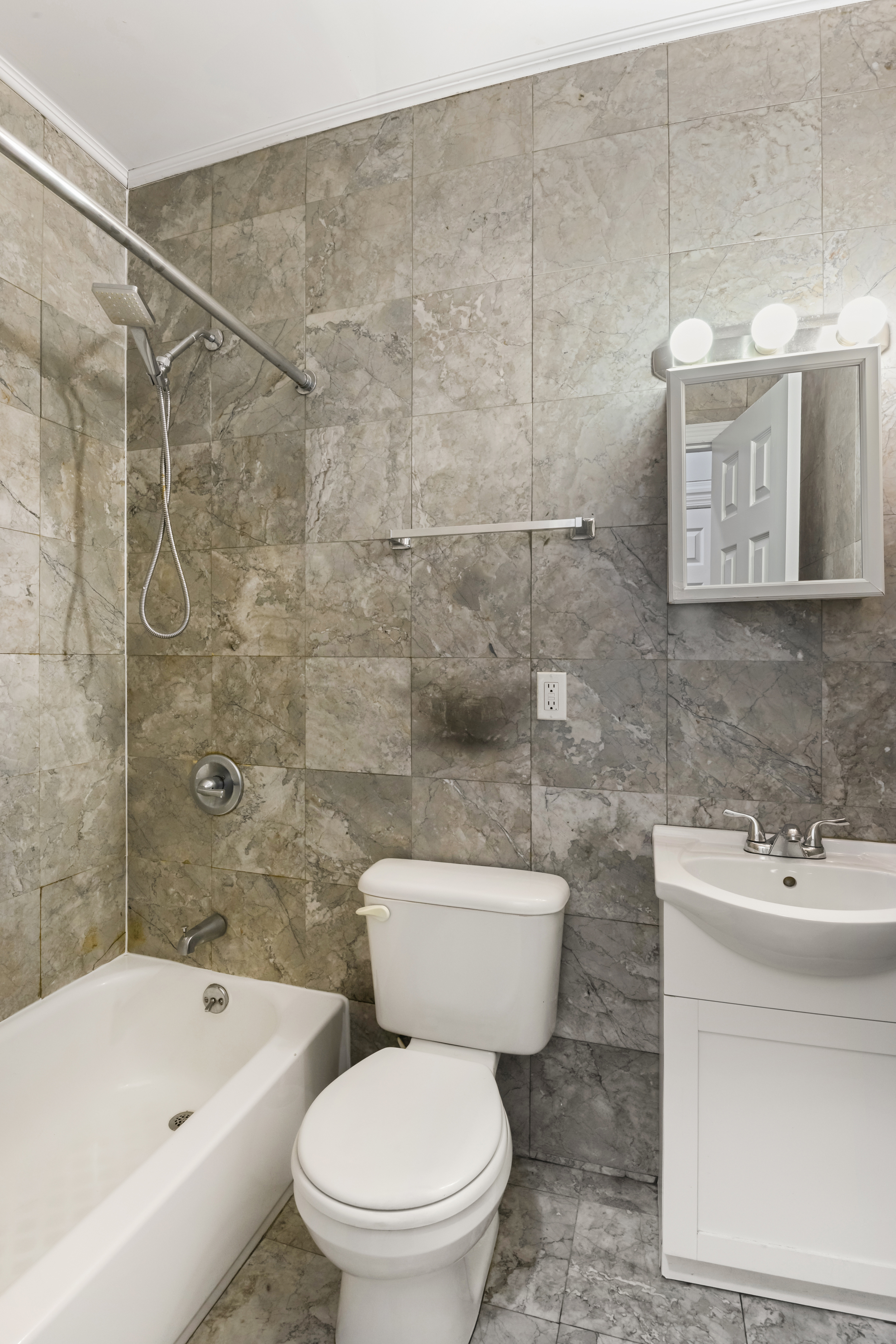 262 12th Street, Unit 1L Brooklyn, NY 11215 - Photo 9 of 10 a white toilet sitting next to a bathroom sink and tub