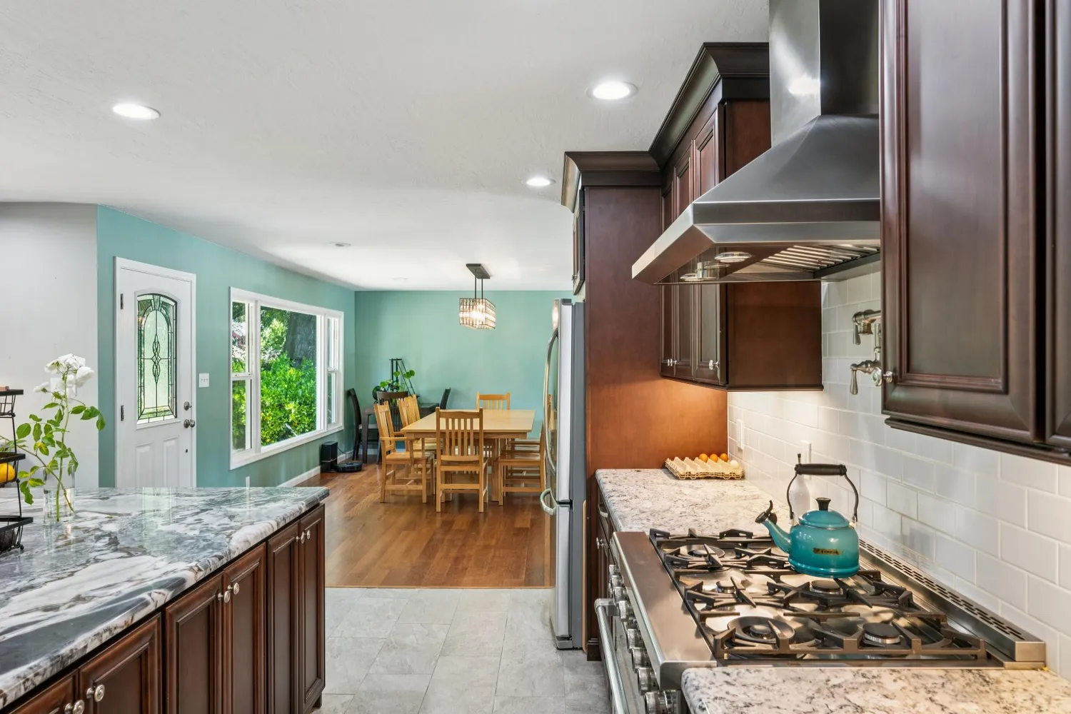 a room with lots of flowers and a wooden floor