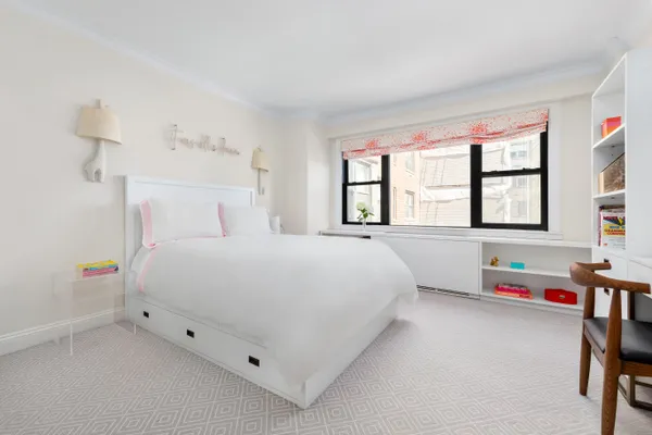 a bedroom with a bed and a large window