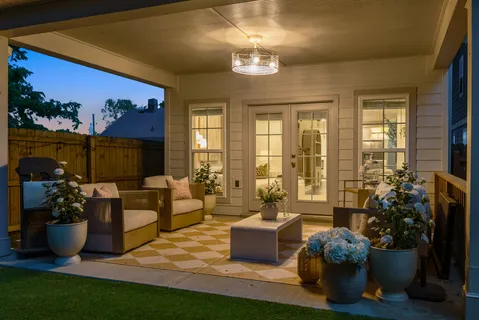 a living room with furniture potted plant and a large window