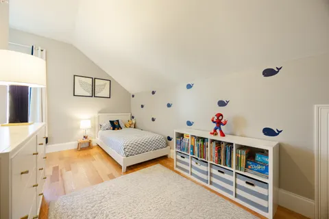 a bedroom with furniture and a book shelf