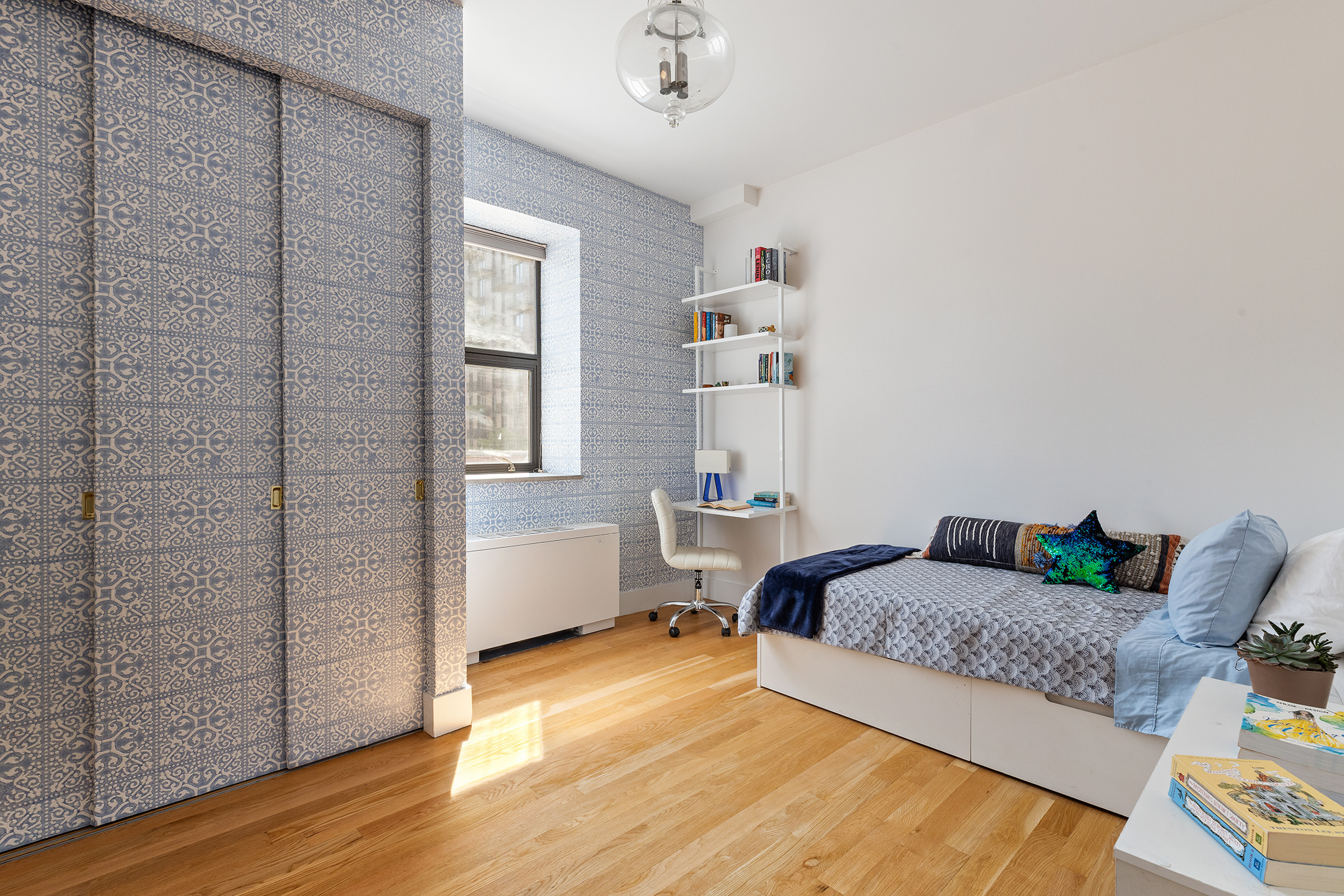 267 West 124th Street, Unit 4B Manhattan, NY 10027 - Photo 10 of 15 a bedroom with a bed and wooden floor