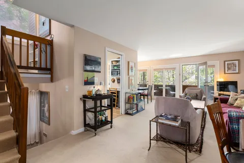 a living room with fireplace furniture and a window