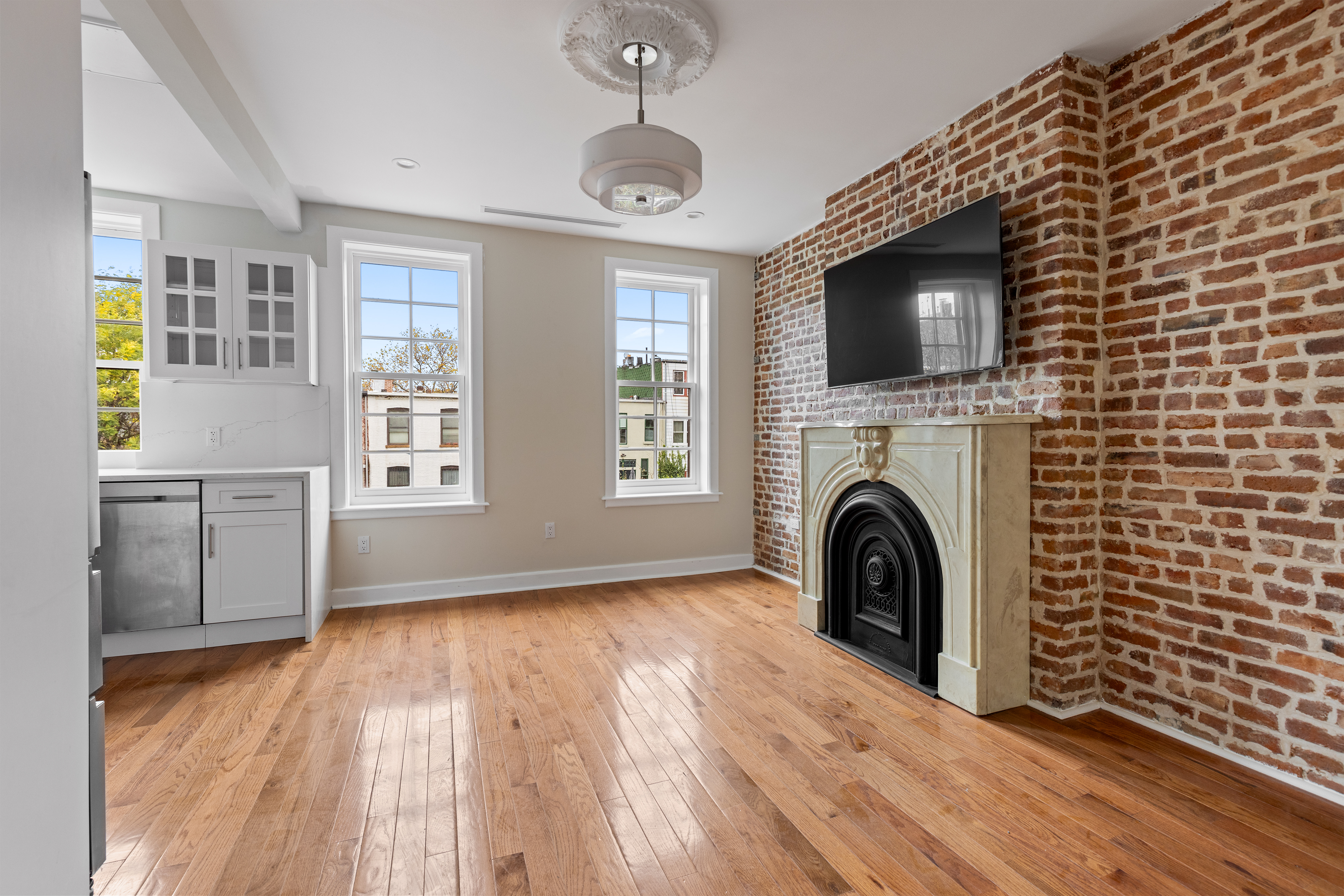 185 Bainbridge Street Brooklyn, NY 11233 - Photo 20 of 23 a view of a livingroom with a fireplace and a window