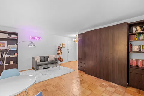 a bedroom with a bed and a book shelf