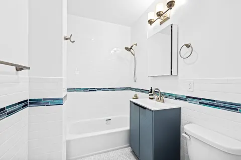 a bathroom with a sink and mirror with toilet