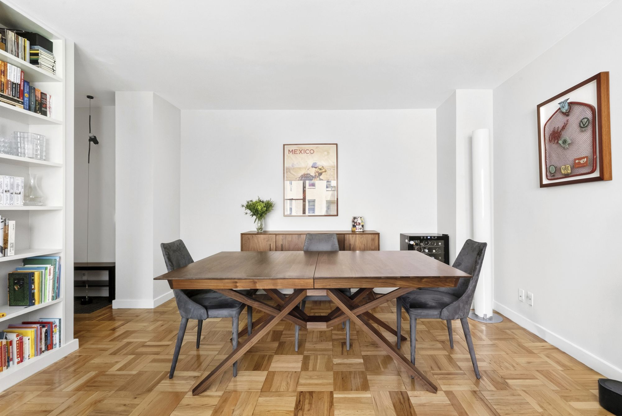 20 East 9th Street, Unit 4T Manhattan, NY 10003 - Photo 2 of 6 a view of a dining room with furniture and a book shelf