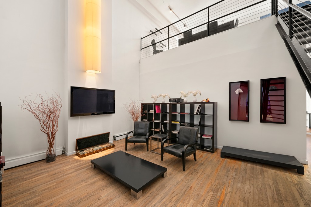 13 Worth Street, Unit 11 Manhattan, NY 10013 - Photo 4 of 9 a living room with furniture and a flat screen tv