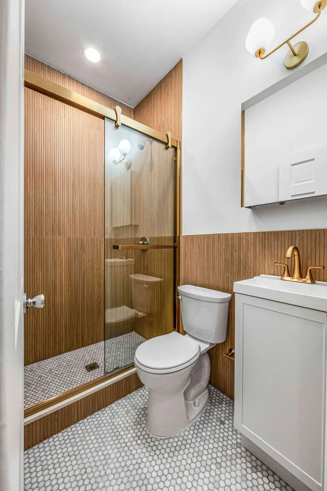 a bathroom with a toilet and a shower