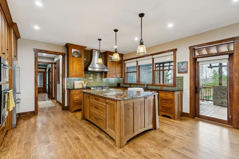 a open kitchen with stainless steel appliances granite countertop a stove and refrigerator