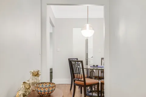 a view of a dining room with furniture and wooden floor
