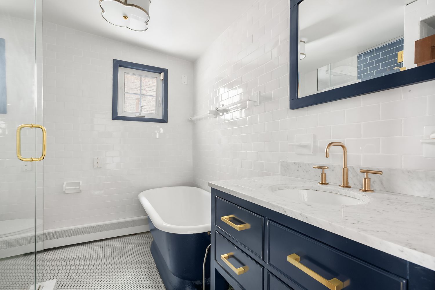 57 Sullivan Street, Unit 4 Manhattan, NY 10012 - Photo 8 of 11 a bathroom with a granite countertop sink a toilet and a mirror
