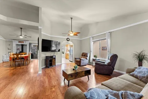 a living room with furniture a fireplace and a flat screen tv