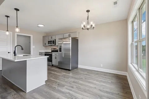 a kitchen with refrigerator and window