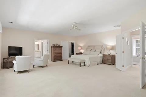 a bedroom with a bed a table and chair