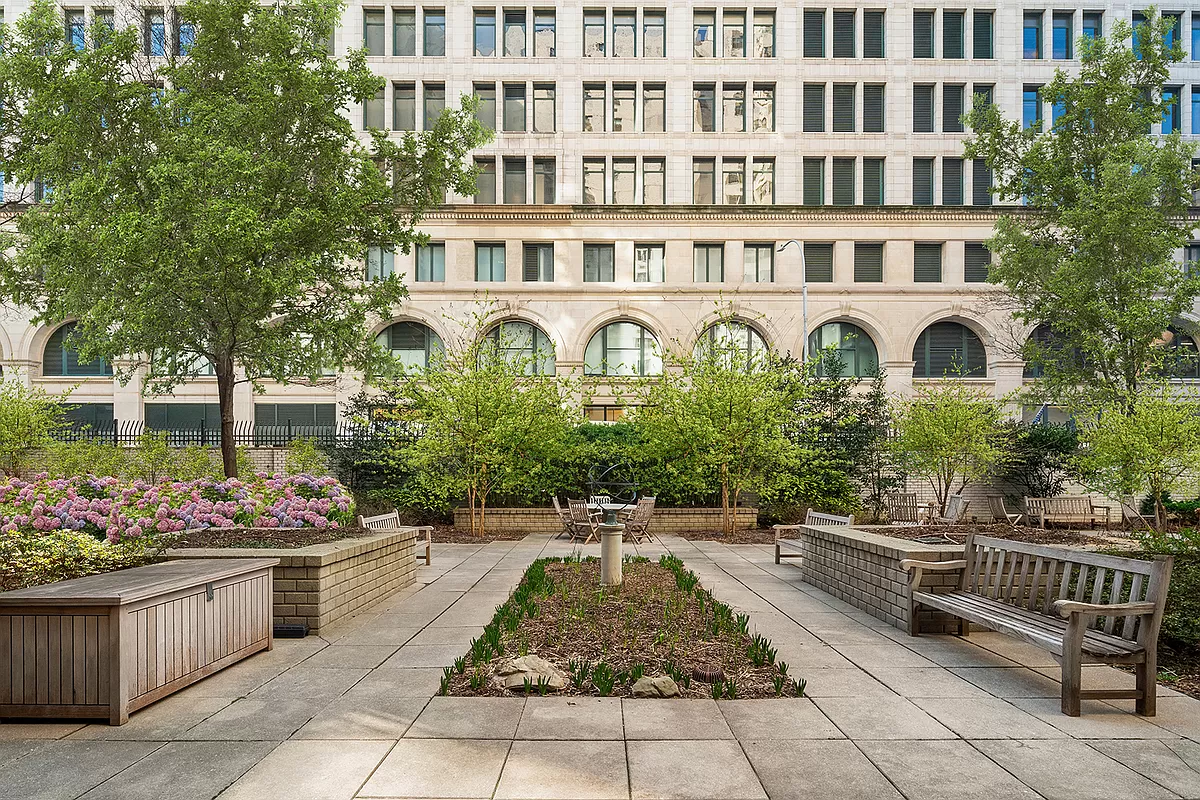 70 East 10th Street, Unit 3M Manhattan, NY 10003 - Photo 9 of 14 a front view of a house with lots of trees and flowers
