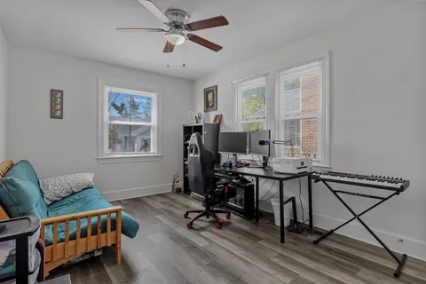 a view of a workspace with furniture and a window