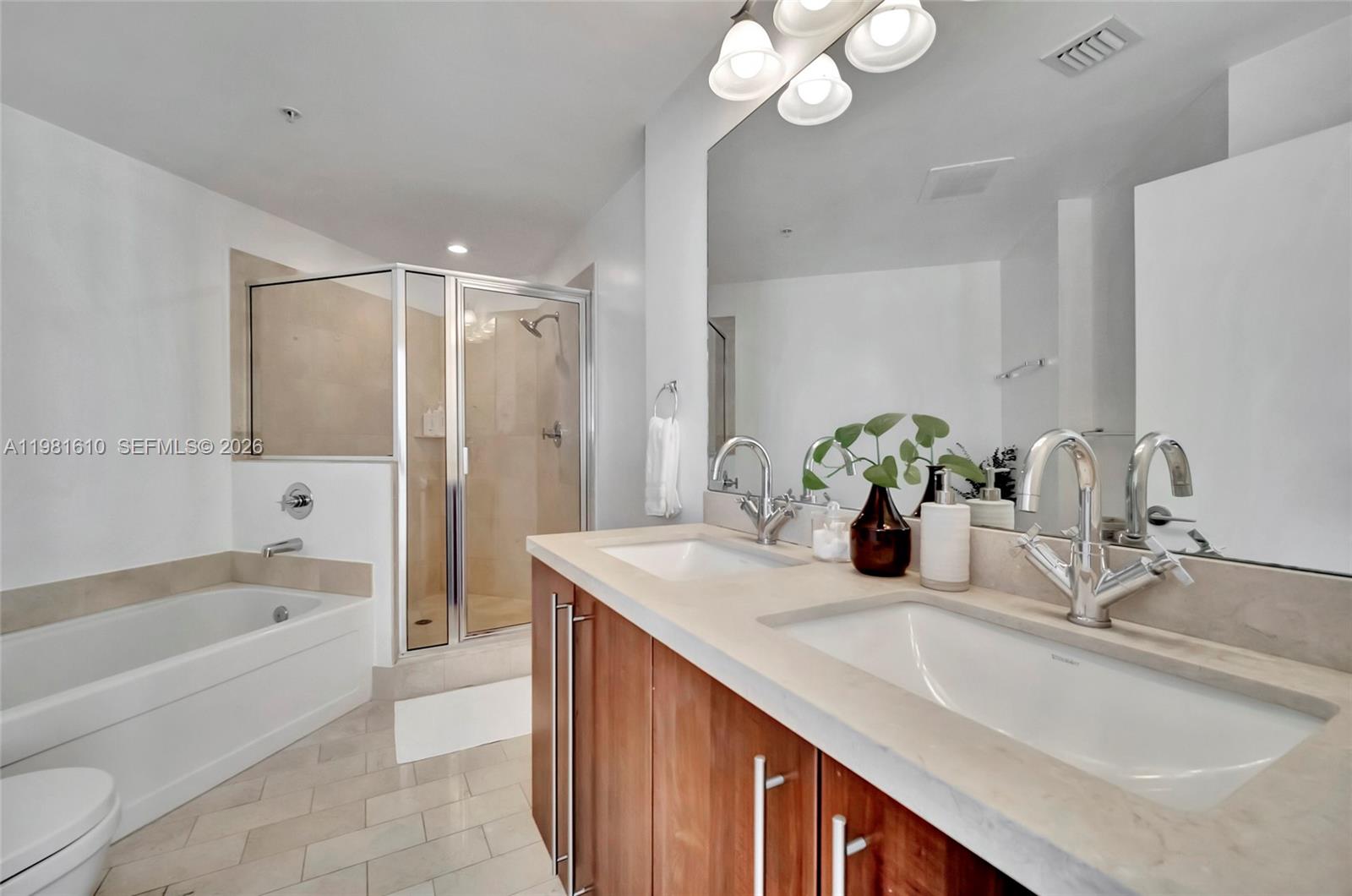 79 Southwest 12th Street, Unit 2201S Miami, FL 33130 - Photo 18 of 33 a bathroom with a granite countertop sink a toilet and bathtub