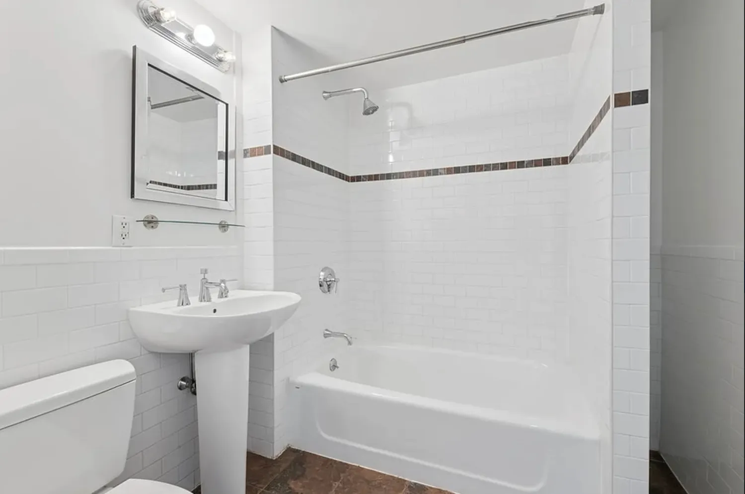 a bathroom with a sink a mirror toilet and bathtub