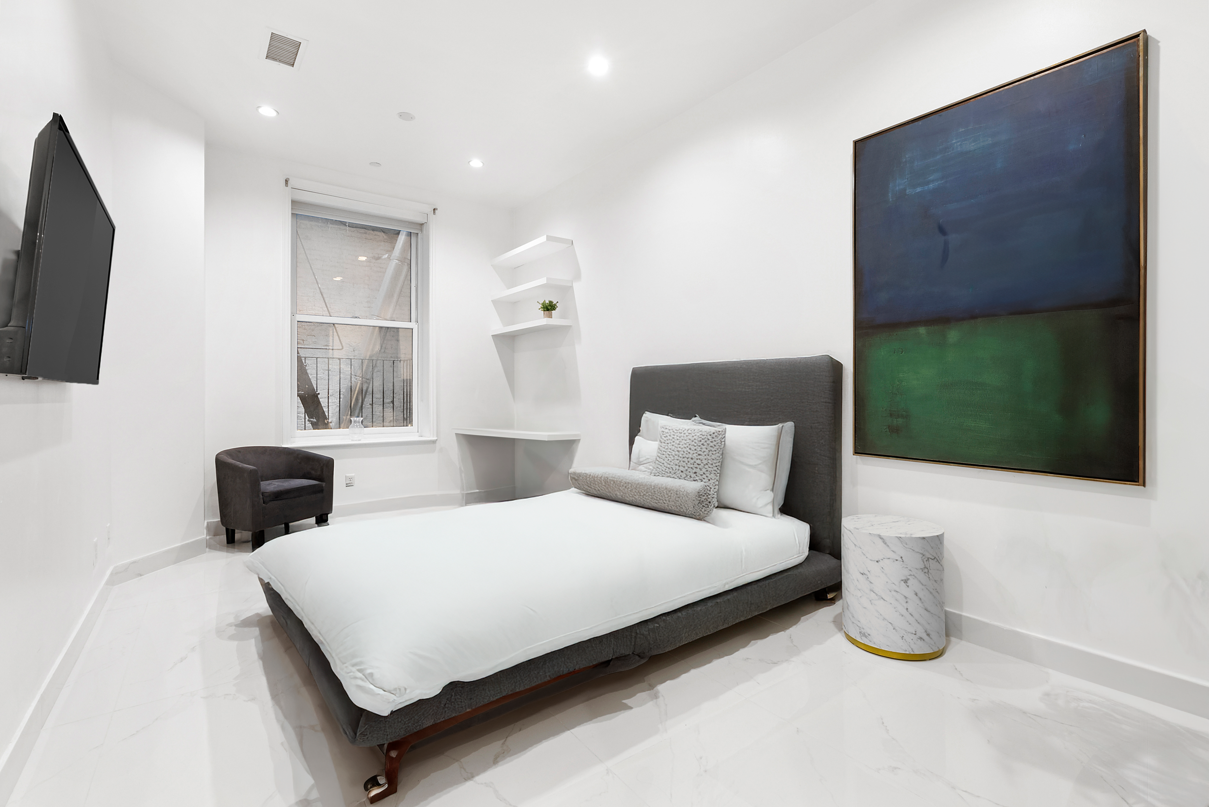 53 Murray Street, Unit 1 Manhattan, NY 10007 - Photo 10 of 12 a bedroom with a bed and a flat screen tv