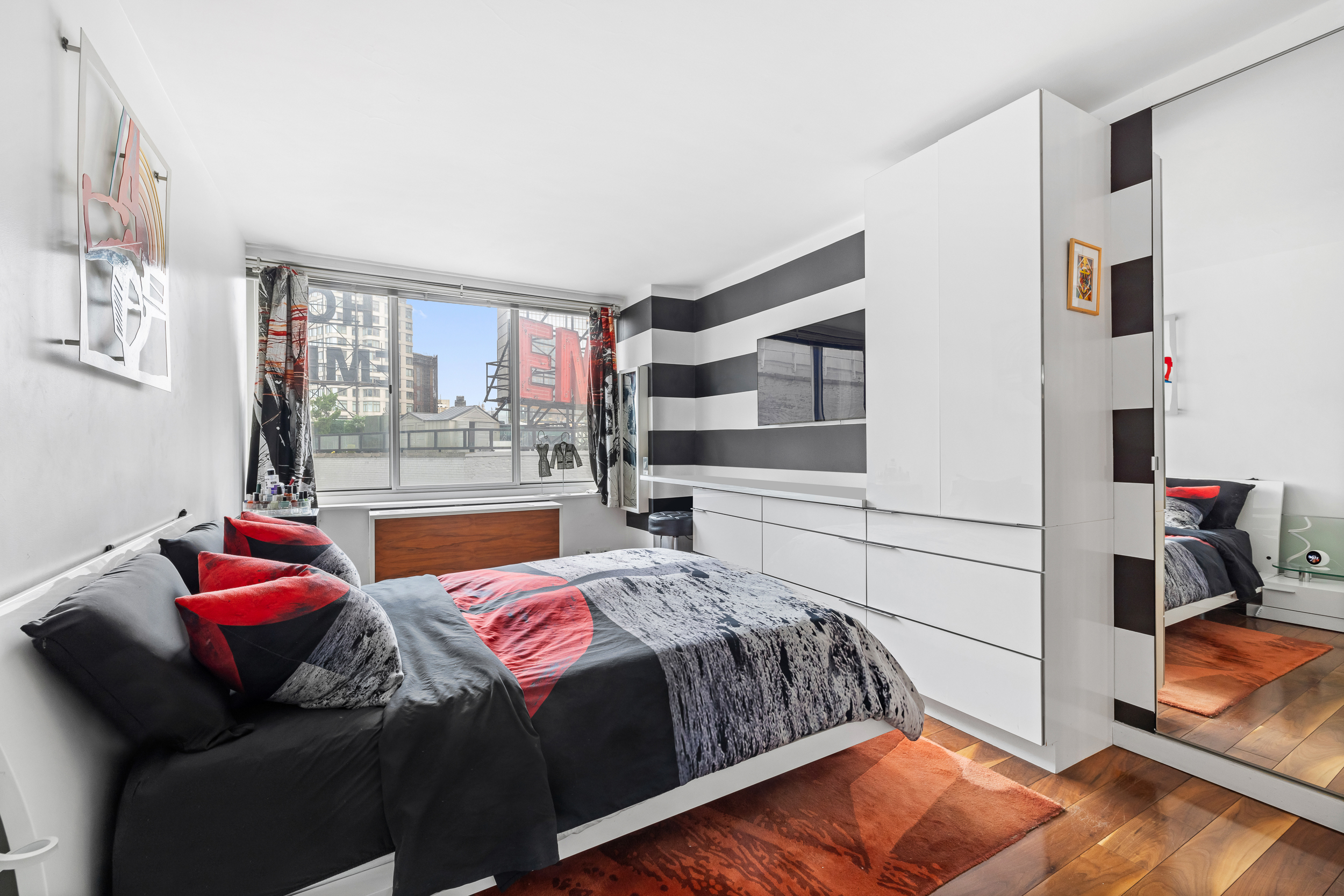 61 West 62nd Street, Unit 16D Manhattan, NY 10023 - Photo 6 of 11 a bedroom with a bed and wooden floor