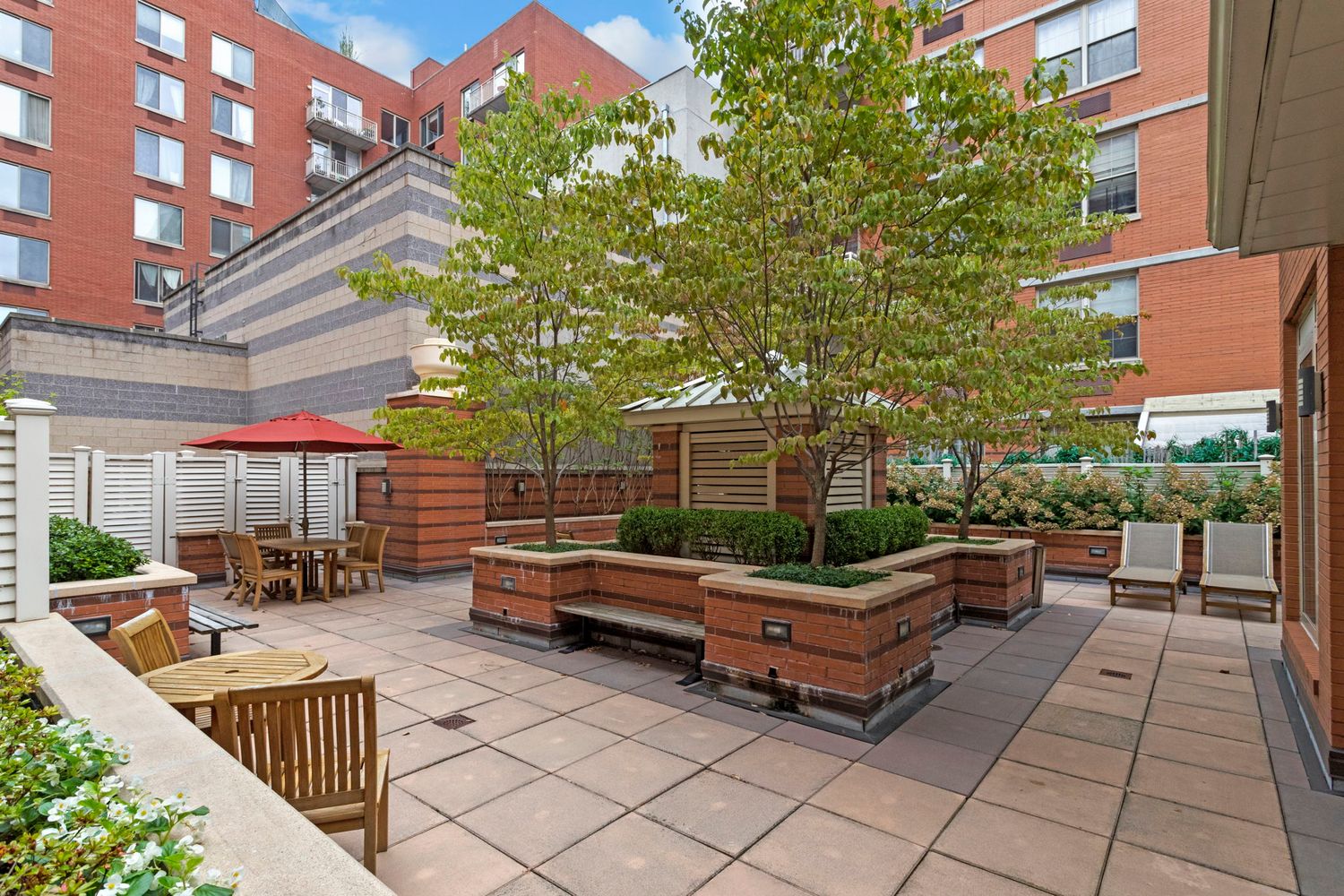 a backyard of a house with barbeque oven table and chairs