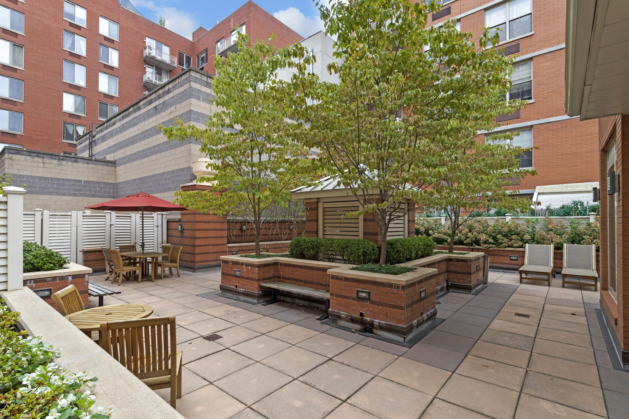313 West 119th Street, Unit PHE Manhattan, NY 10027 - Photo 18 of 19 a backyard of a house with barbeque oven table and chairs