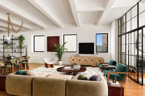 a living room with furniture wooden floor and a flat screen tv