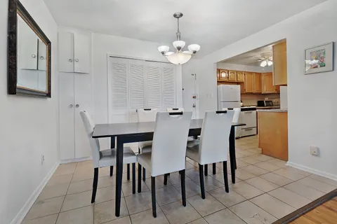 a view of a dining room with furniture and a chandelier