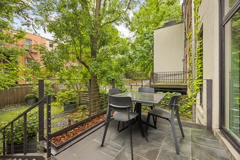 a front view of a house with a yard and fountain