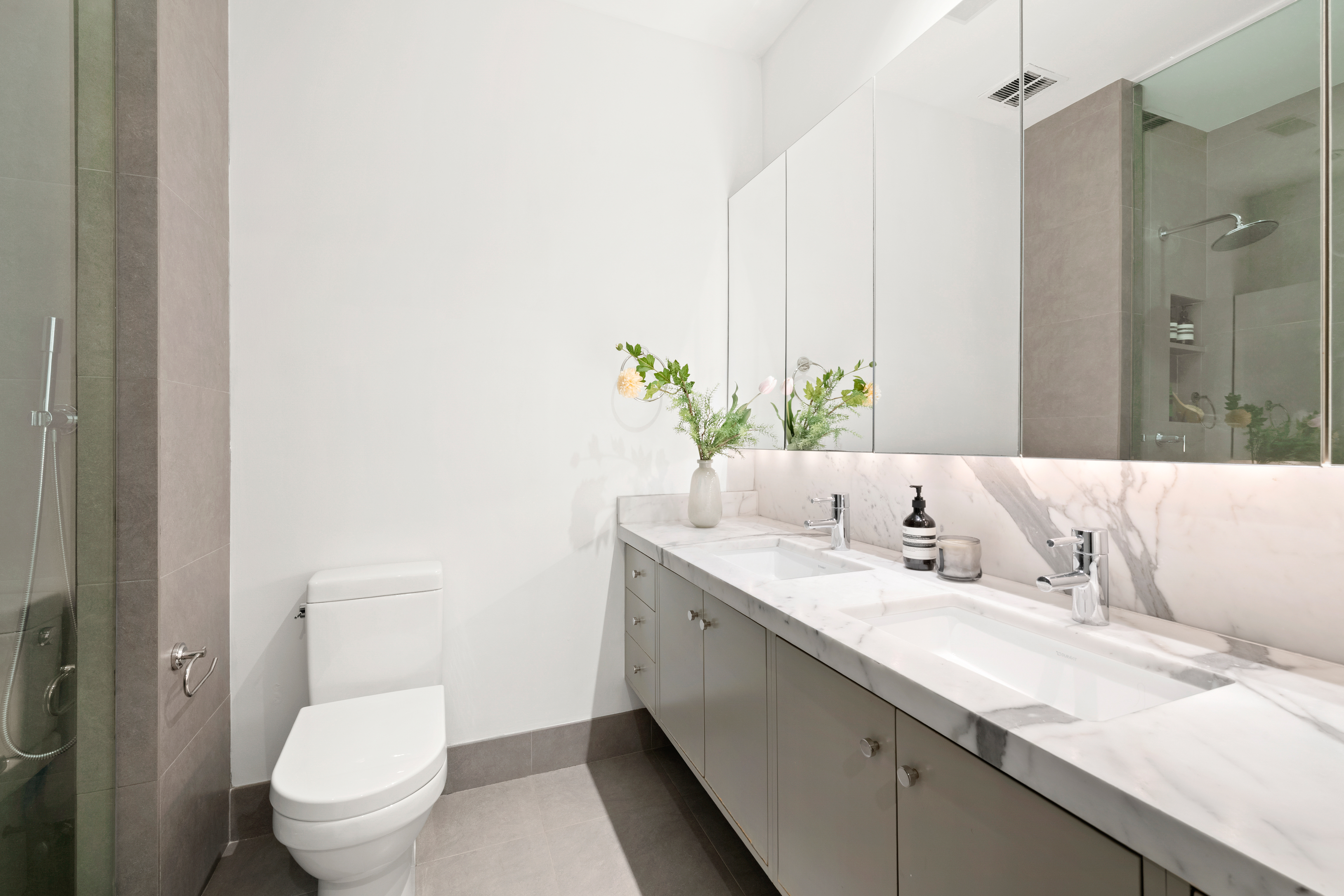 53 North Moore Street, Unit 2F East Manhattan, NY 10013 - Photo 11 of 12 a bathroom with a granite countertop sink and a toilet