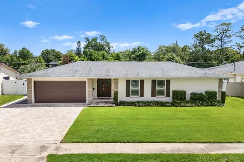 a front view of house with yard and green space