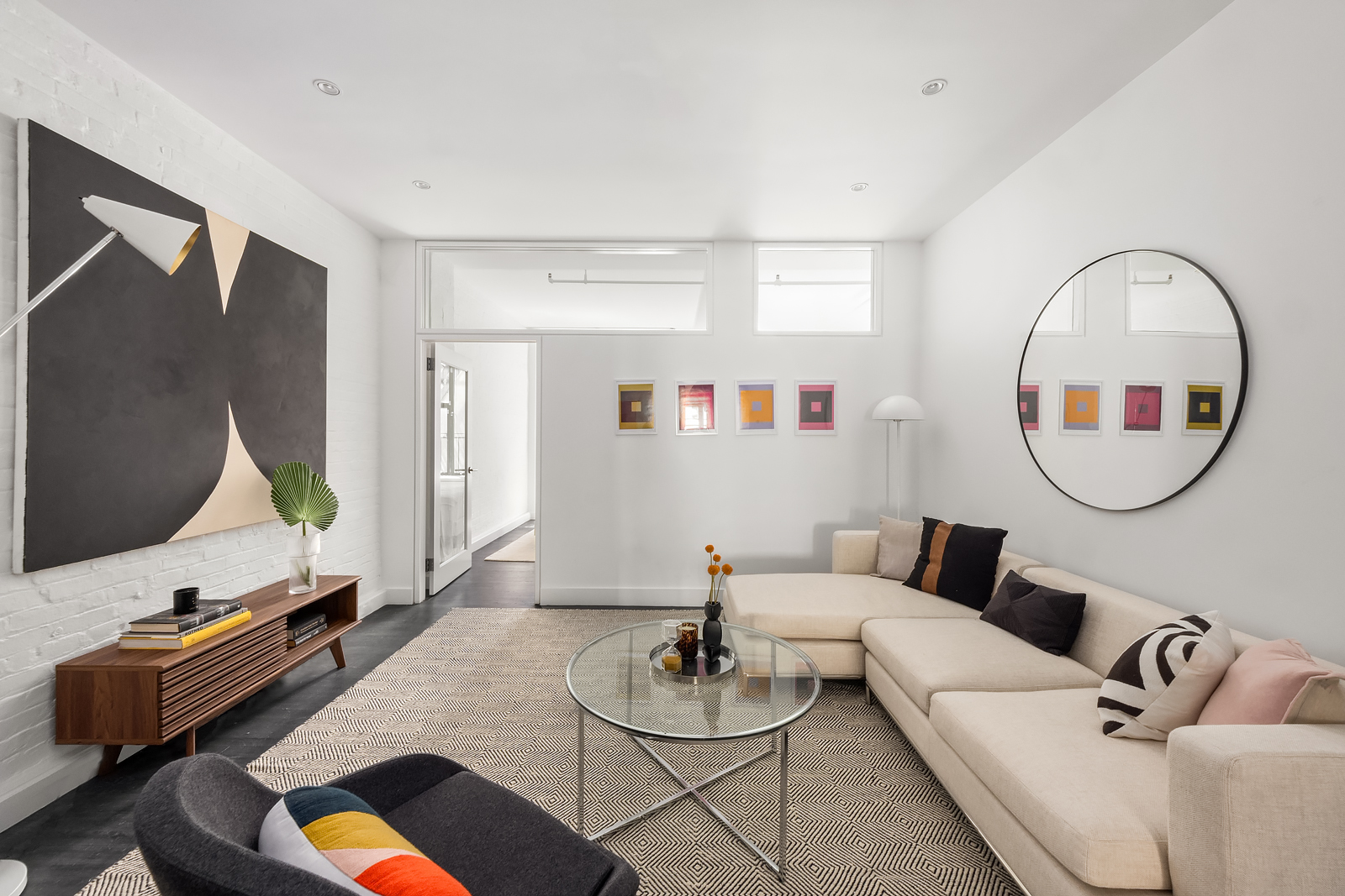 36 West 15th Street, Unit 4 Manhattan, NY 10011 - Photo 12 of 21 a living room with furniture and a mirror