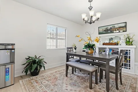 a dining room with furniture and window