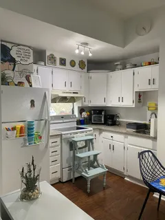 a kitchen with stainless steel appliances kitchen island granite countertop a sink and cabinets