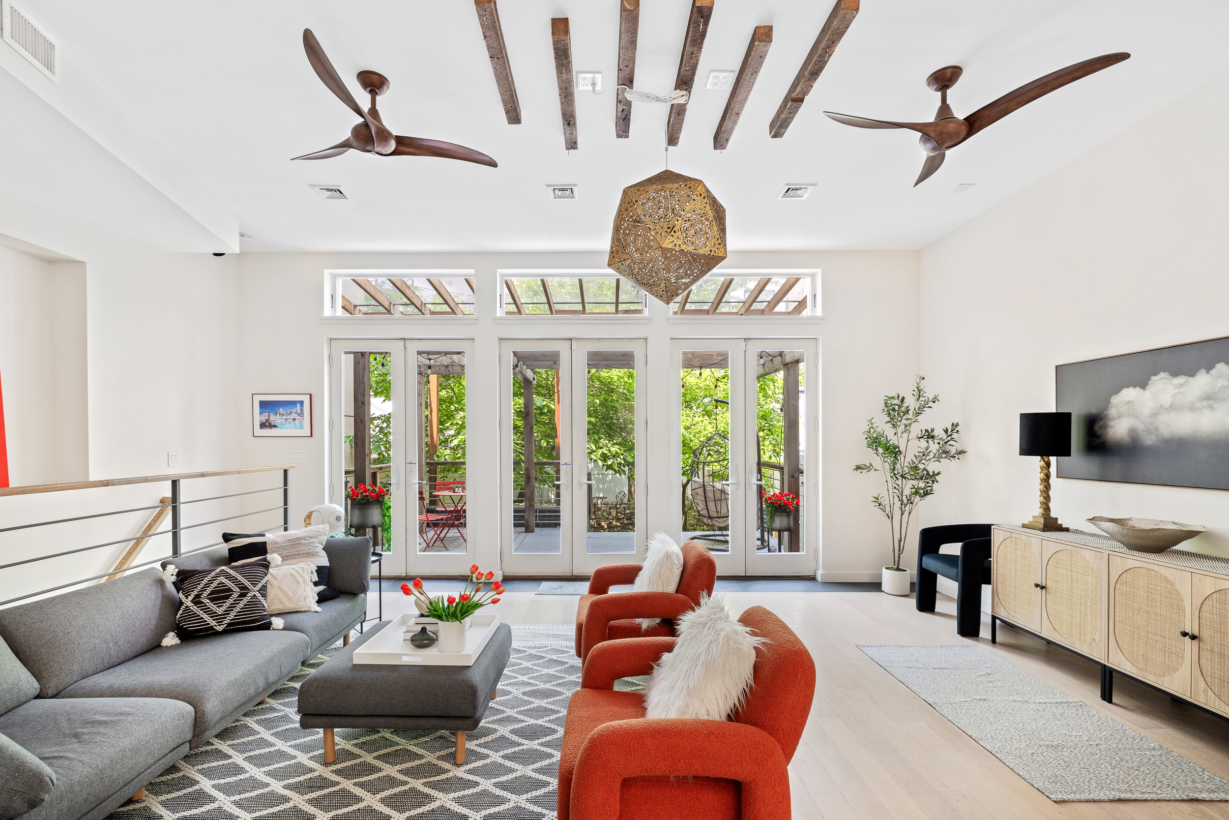 65 Jackson Street Brooklyn, NY 11211 - Photo 1 of 36 a living room with furniture a flat screen tv and a large window